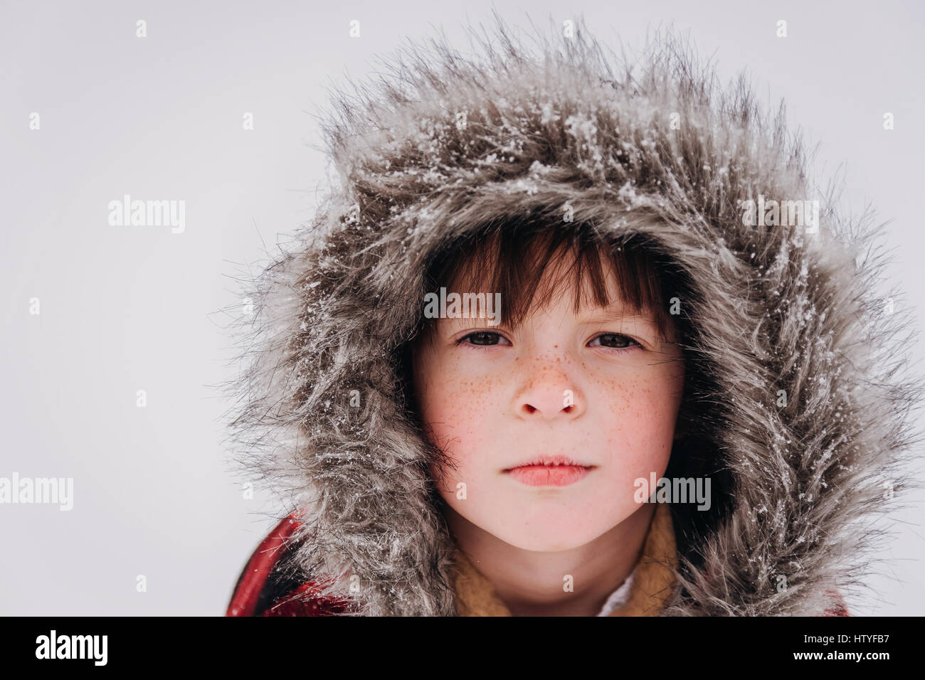 Portrait of serious girl in hooded parka Stock Photo