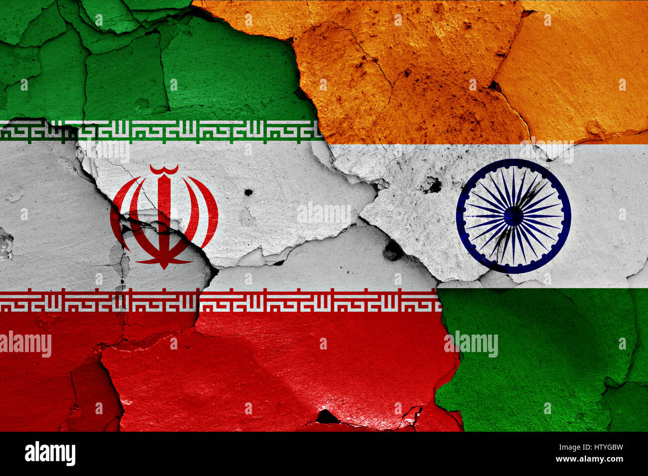 flags of Iran and India painted on cracked wall Stock Photo