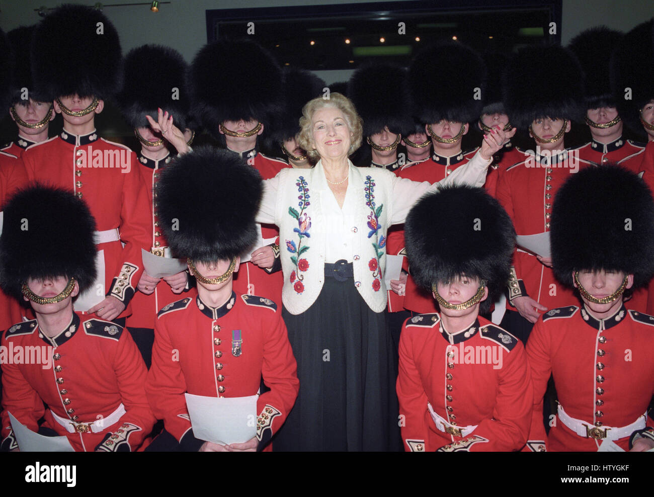 Dame Vera Lynn singing with the troops at a London recording studio, where she recorded new versions of the wartime favourite 'We'll Meet Again' and 'White Cliffs of Dover' with members of the 2nd Battalion Grenadier Guards as a backing choir. Stock Photo