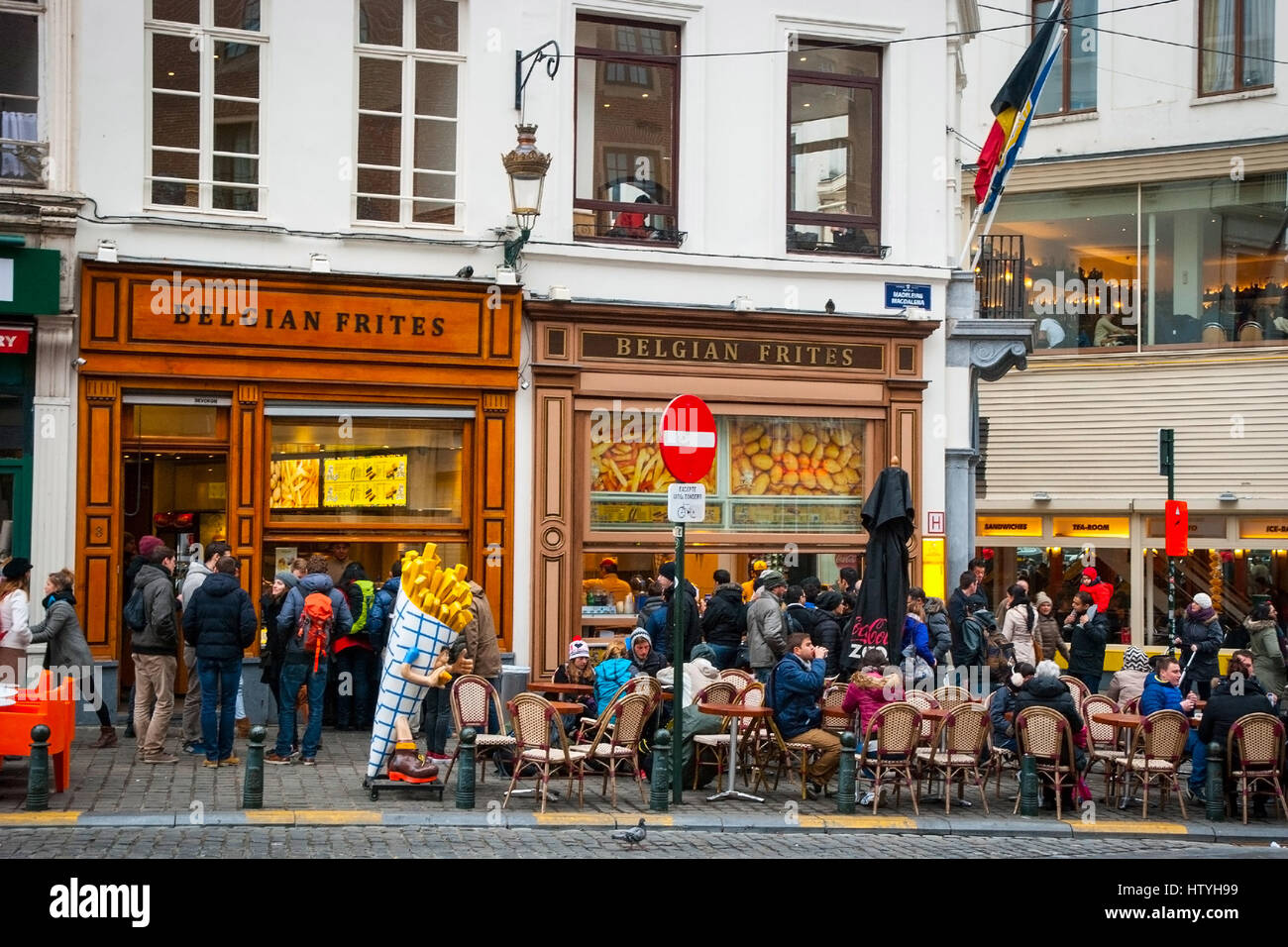 BRUSSELS, BELGIUM - MARCH 15: People enjoying traditional belgium fries at one of many belgian frites restaurants in Brussels, March 15, 2015 Stock Photo
