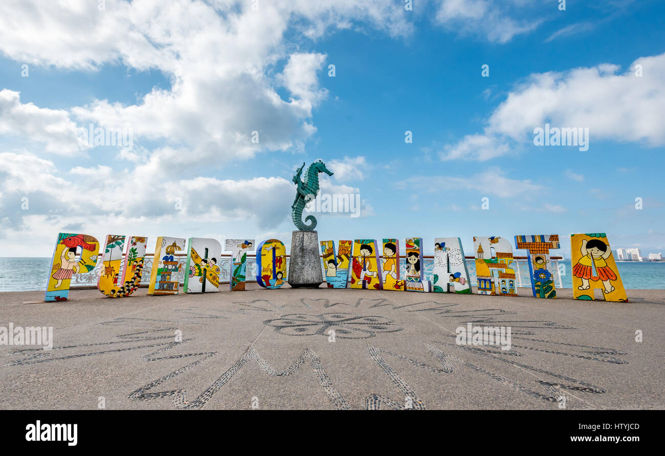 The colorful Puerto Vallarta sign on the Malecon with “Caballero del Mar” The Seahorse sculpture by Rafael Zamarripa, 1976, in the middle of the words Stock Photo