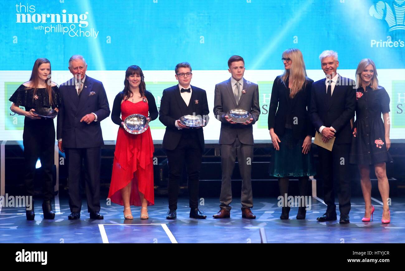 The Prince of Wales (2nd left) on stage with the winners of the Home Sense Young Achiever of the Year Award (left to right) Alisha Mardon, Nicola Staff, Matt Dalton and Ryan Morris with Phillip Schofield (2nd right), Emilia Fox (right) and guest during the Prince's Trust Celebrate Success Awards at the London Palladium. Stock Photo