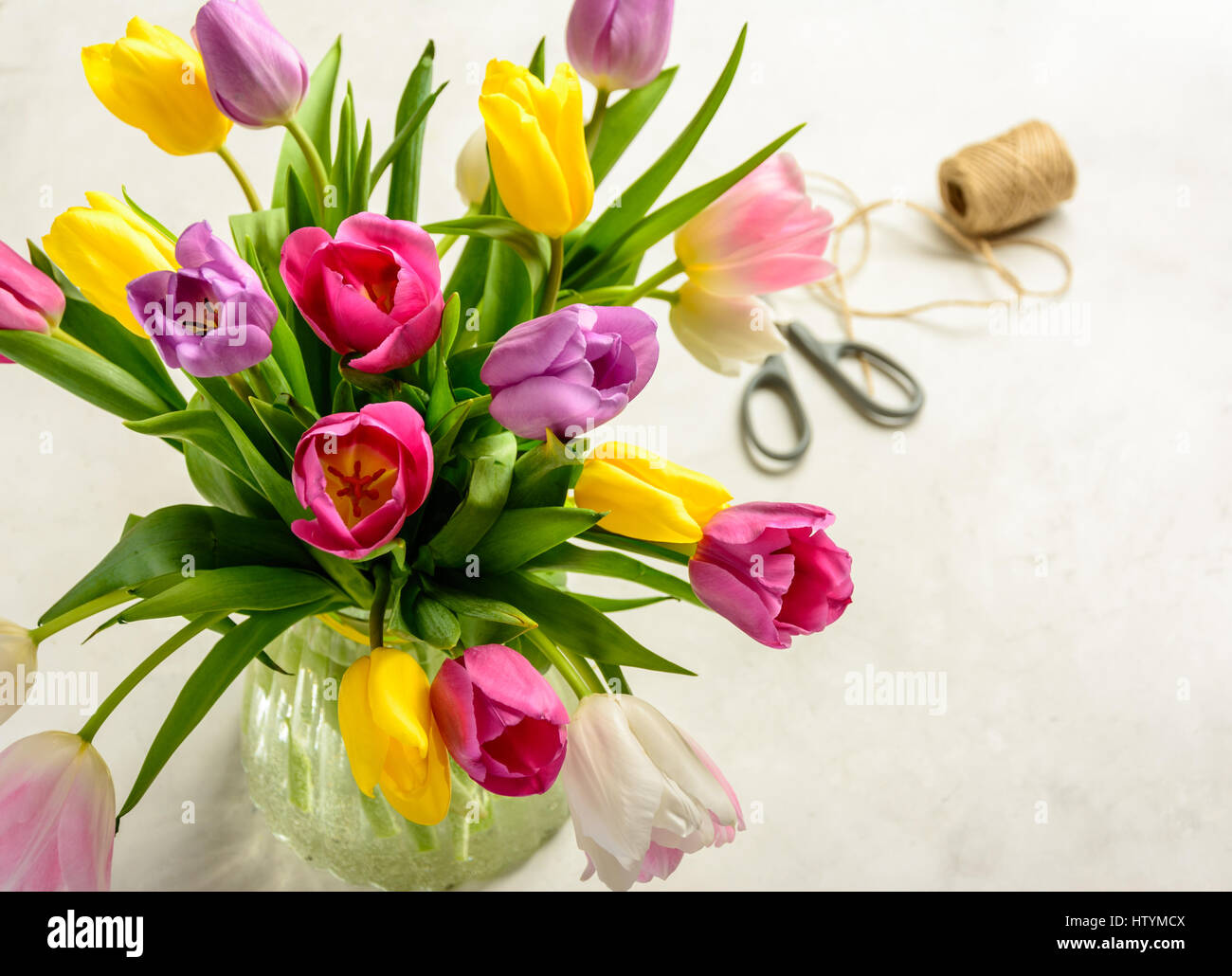 Beautiful festive bouquet of tulips on white background. Copy space. Stock Photo