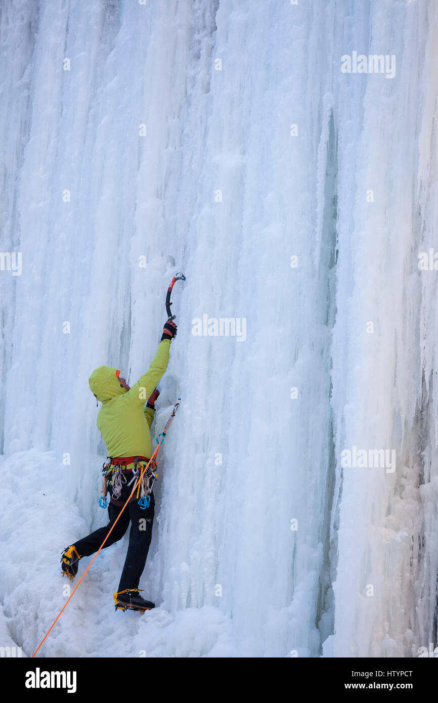 An ice climber climbing the frozen Buttermilk Falls in Hamilton