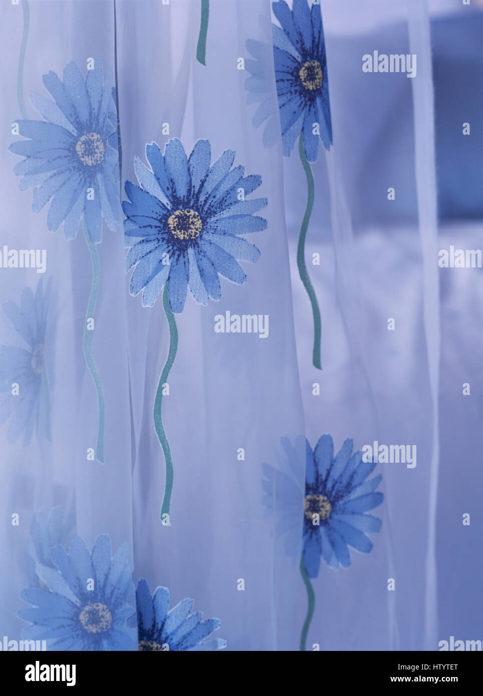Closeup of a voile curtain with blue embroidered daisies Stock Photo