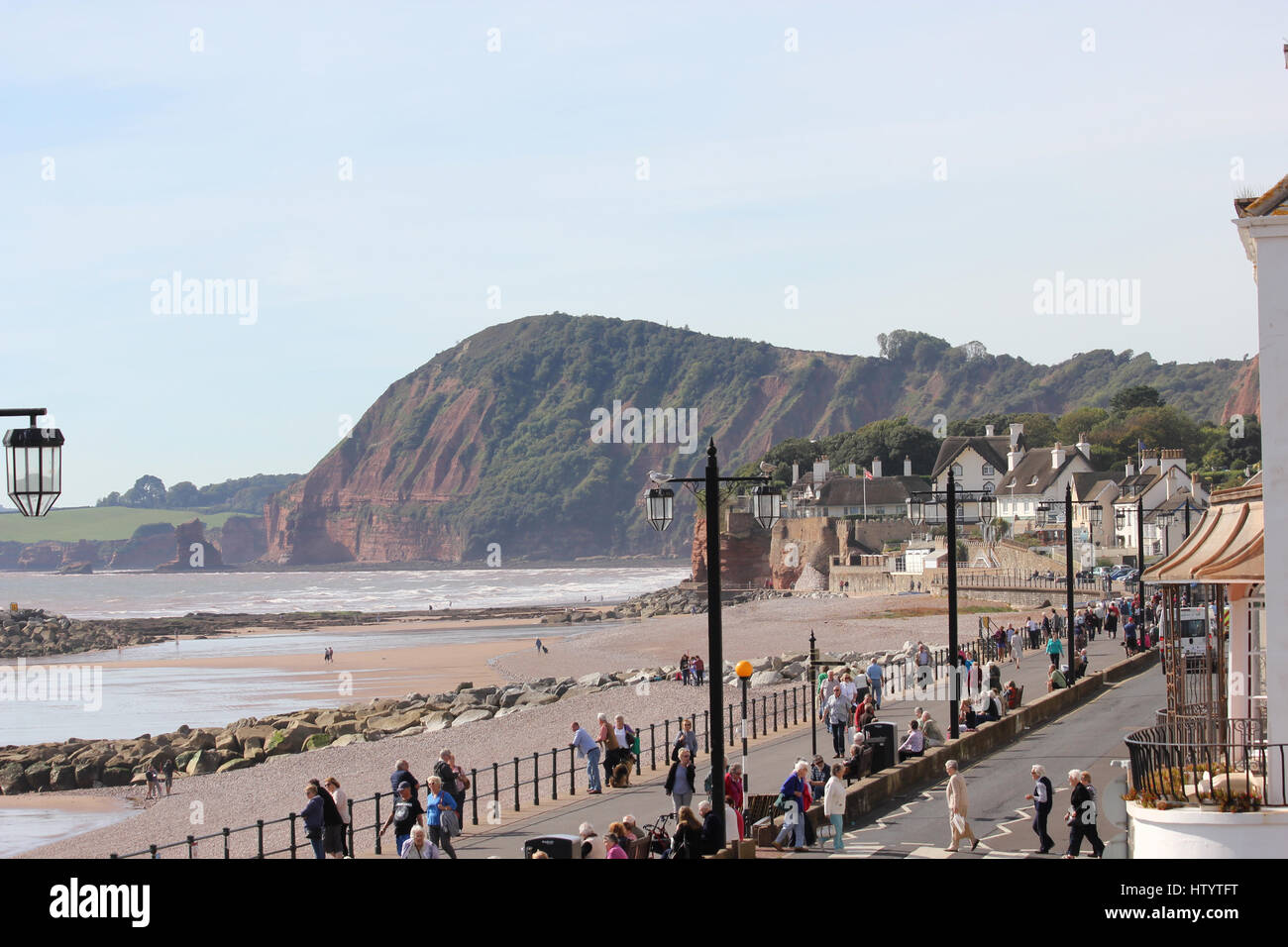 Looking west towards Connaught Gardens and the cliffs around Ladram Bay from the sea front above the Esplanade, Sidmouth, Devon, on a sunny day Stock Photo