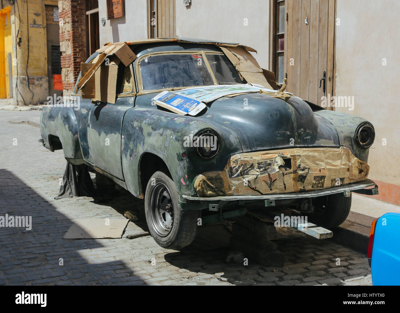 The shell of an Chevrolet car body undergoing restoration on the road side in Havana, Cuba Stock Photo