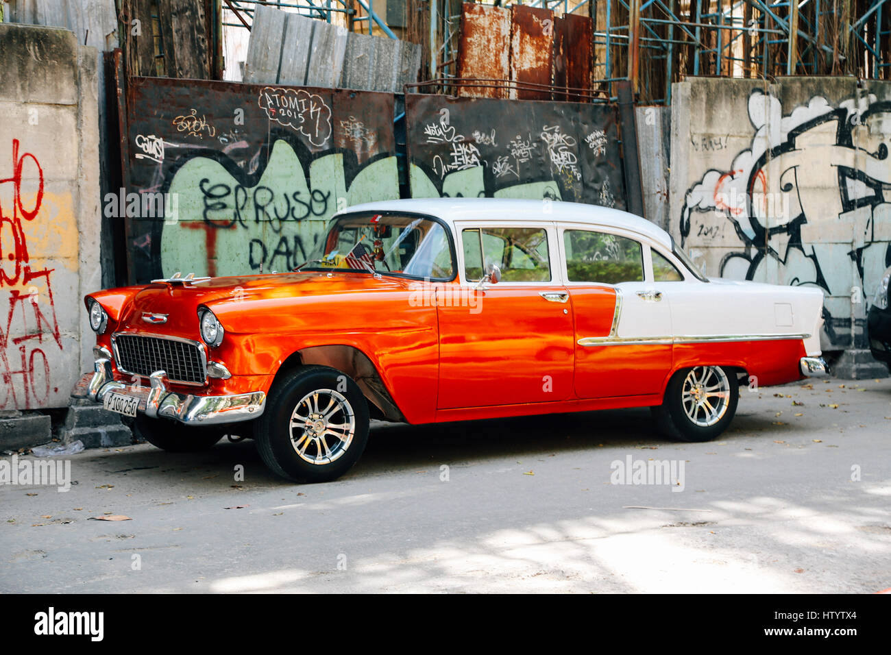 A classic white and orange Chevrolet car on a road in Havana, Cuba Stock Photo