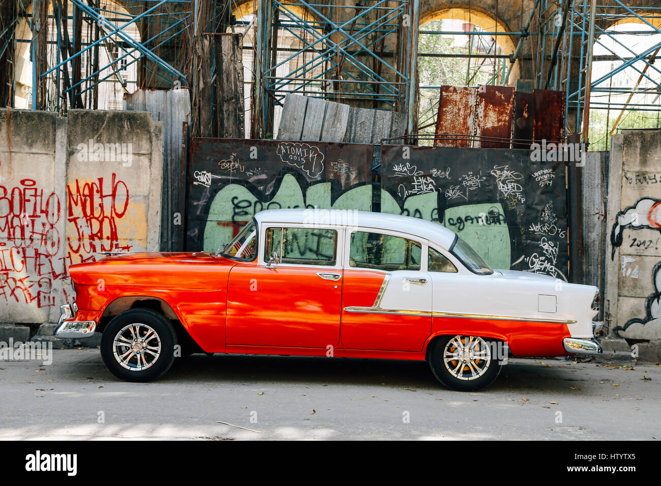 A classic white and orange Chevrolet car on a road in Havana, Cuba Stock Photo