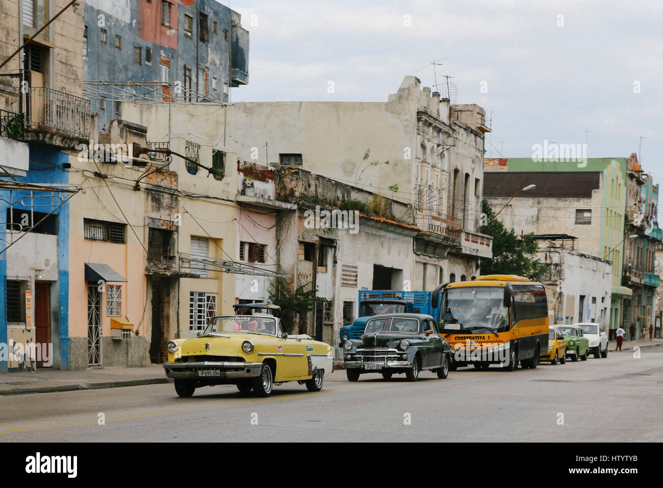 Classic American style cars driving on a road in Havana, Cuba Stock Photo