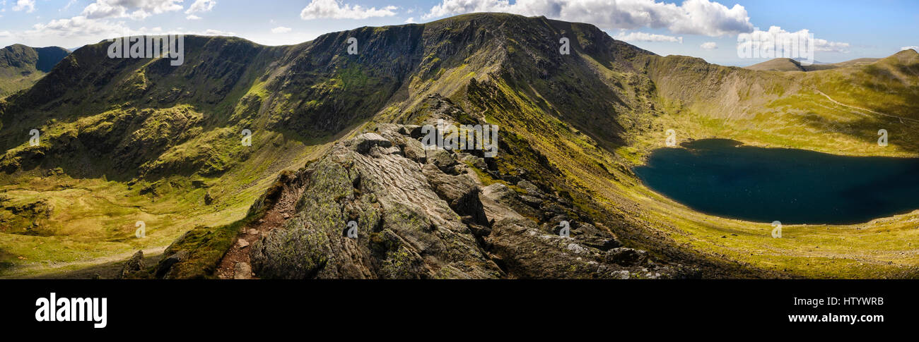 Mountain panorama of Helvellyn one of the Lakeland Fells and Red Tarn from Striding Edge in the Lake District Cumbria England Stock Photo