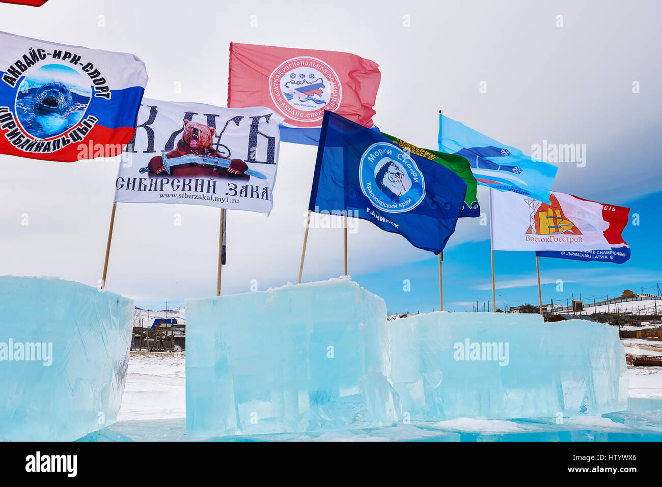 SAHYURTA, IRKUTSK REGION, RUSSIA - March 11.2017: Cup of Baikal. Winter Swimming Competitions. Flags of different clubs for winter swimming on ice cub Stock Photo