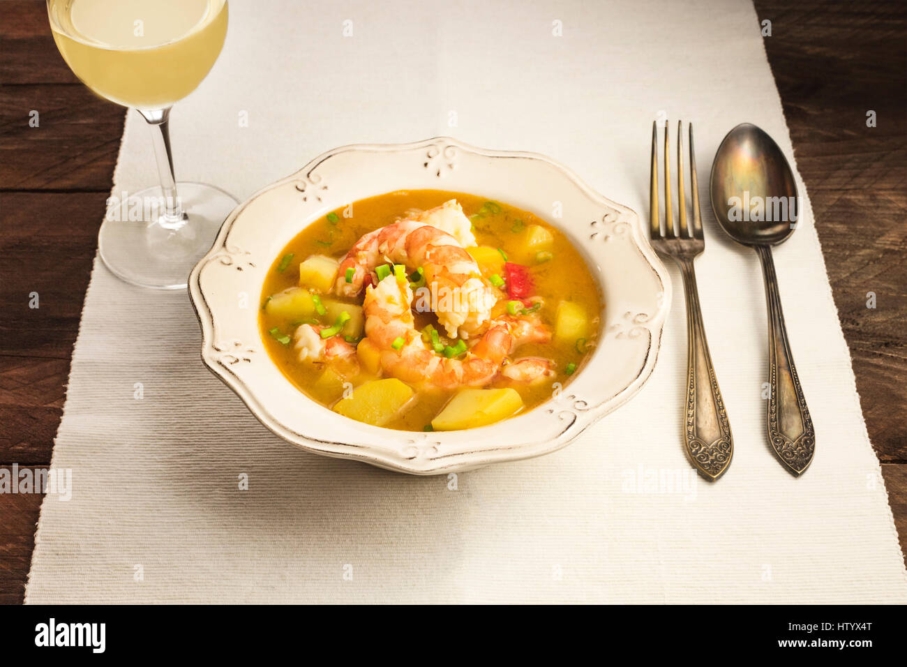 Shrimp and potato dish with wine and copyspace Stock Photo - Alamy