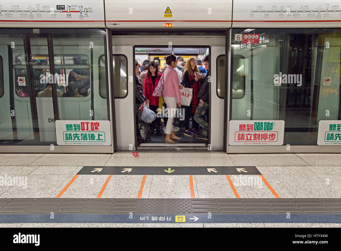 Commuters onboard waiting for the train to depart on the MTR - underground railway system in Hong Kong. Stock Photo