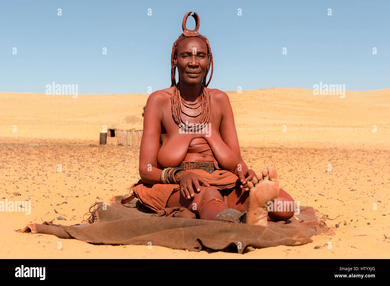 Himba woman adorned with the Erembe headpiece and other jewelery. Stock Photo