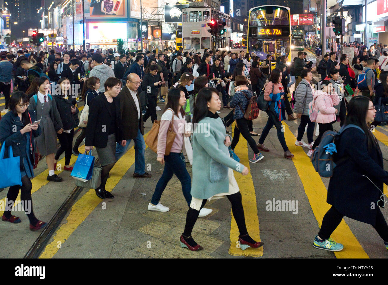 A busy bustling intersection in Causeway Bay, Hong Kong, for pedestrians crossing the street with some motion blur. Stock Photo