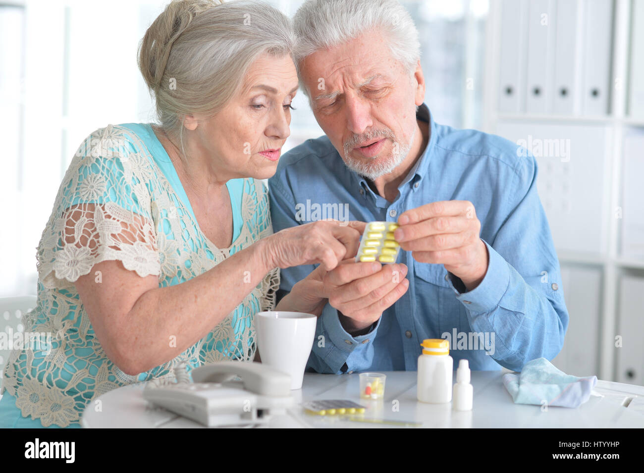 Elderly couple with pills Stock Photo