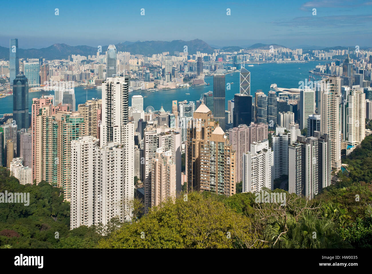 An aerial view from Sky Terrace 428 on top of the Peak Tower over Hong Kong and Victoria Bay on a clear sunny day with blue sky. Stock Photo