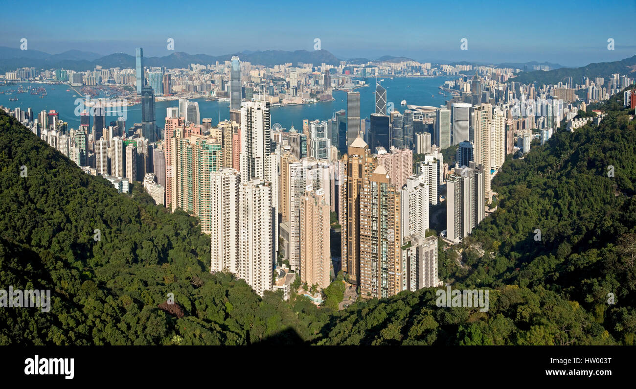 A 2 picture stitch panoramic aerial view from Sky Terrace 428 on top of the Peak Tower over Hong Kong and Victoria Bay on a clear day with blue sky. Stock Photo