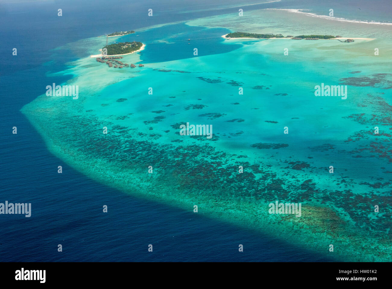 Maldives, flight over the atolls and islands in the Indian Ocean. Stock Photo
