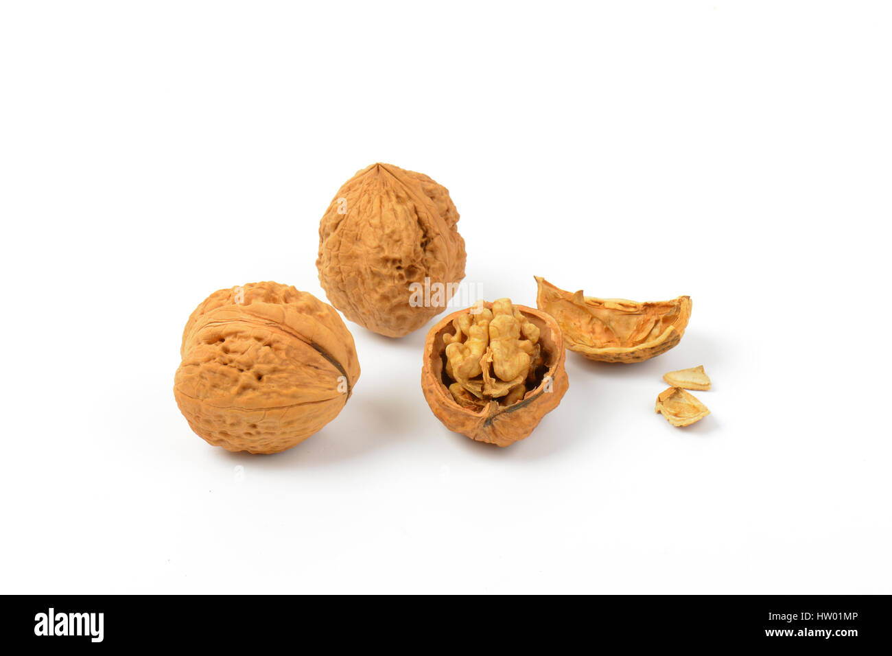 whole and cracked walnuts on white background Stock Photo