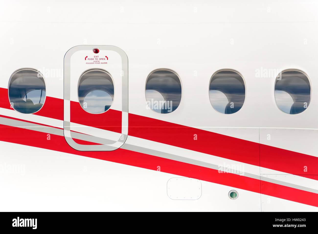 emergency exit doorway on the fuselage of a passenger aircraft Stock Photo