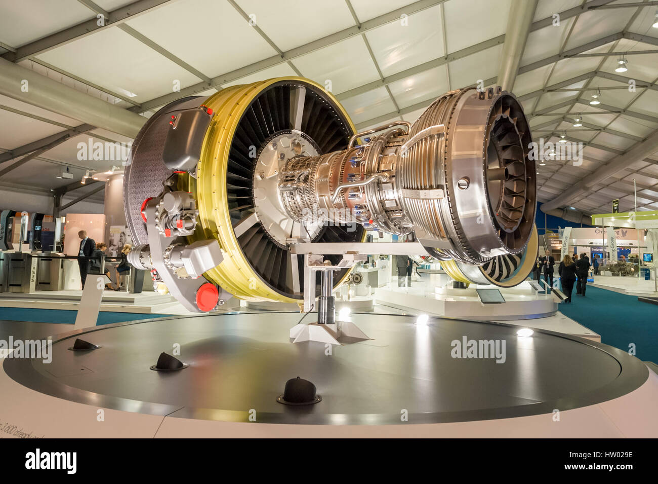 Exhibition stands displaying large jet engines and other components used in the aviation industry at the Farnborough, Stock Photo