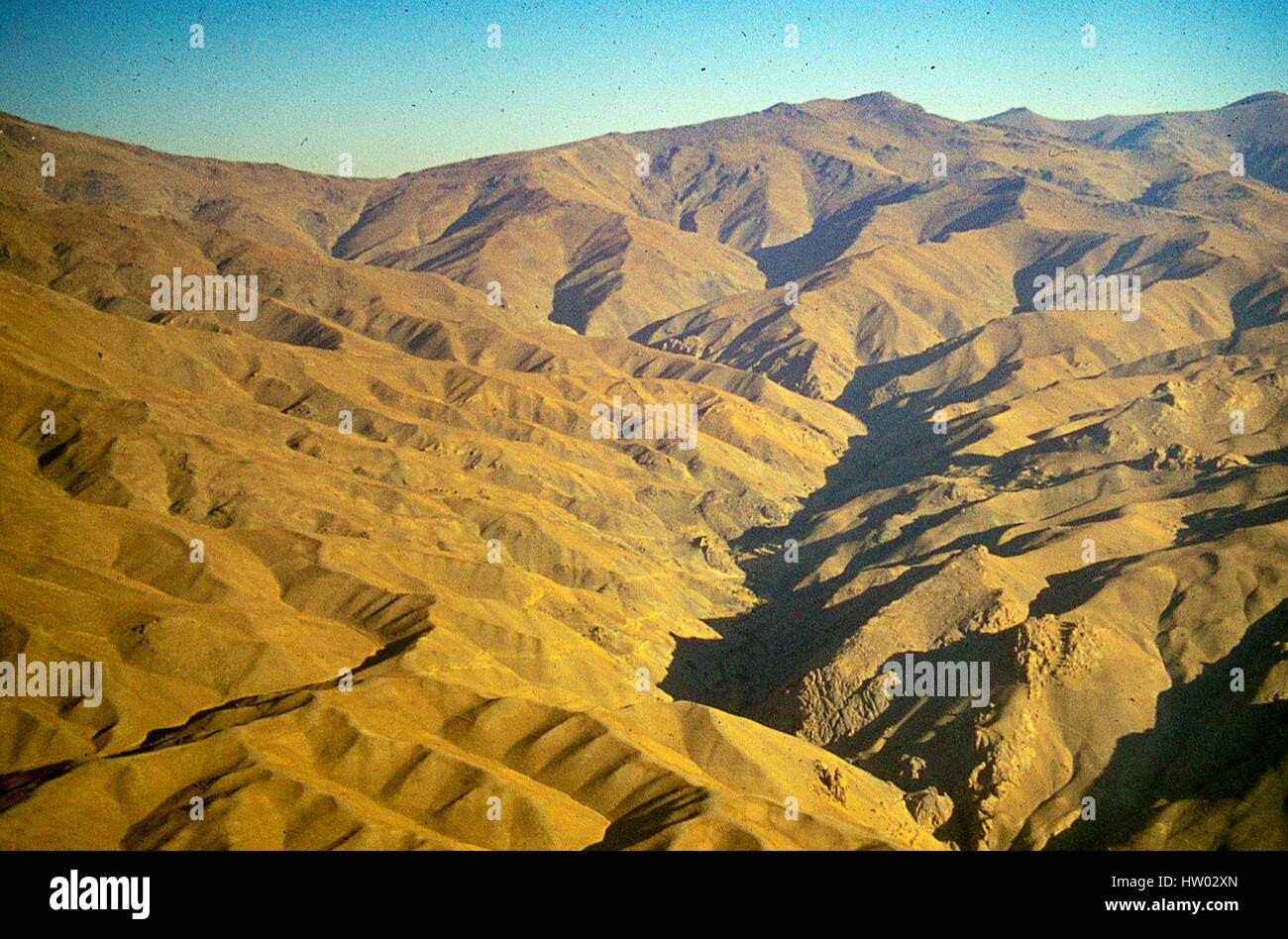 Panoramic aerial view from a flight over the Hindu Kush mountains surrounding the Bamiyan valley, in the Hazarajat region of central Afghanistan, November, 1975. Stock Photo