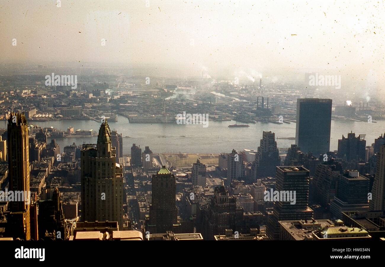 Panoramic view facing east of Midtown Manhattan between 42nd and 52nd Streets, from Park Avenue down to the East River, in New York City, New York, 1957. The General Electric Building stands at left edge of frame, located at 570 Lexington at 51st Street. Seen in profile to the right is the Waldorf Astoria Hotel, on Park Avenue between 49th and 50th Streets. In the background, the southern tip of Welfare Island (Roosevelt Island) juts out into the East River. On the Queens shoreline further back, the 11th Street Anable Basin channel in Long Island City stands exactly across from 48th Street in  Stock Photo