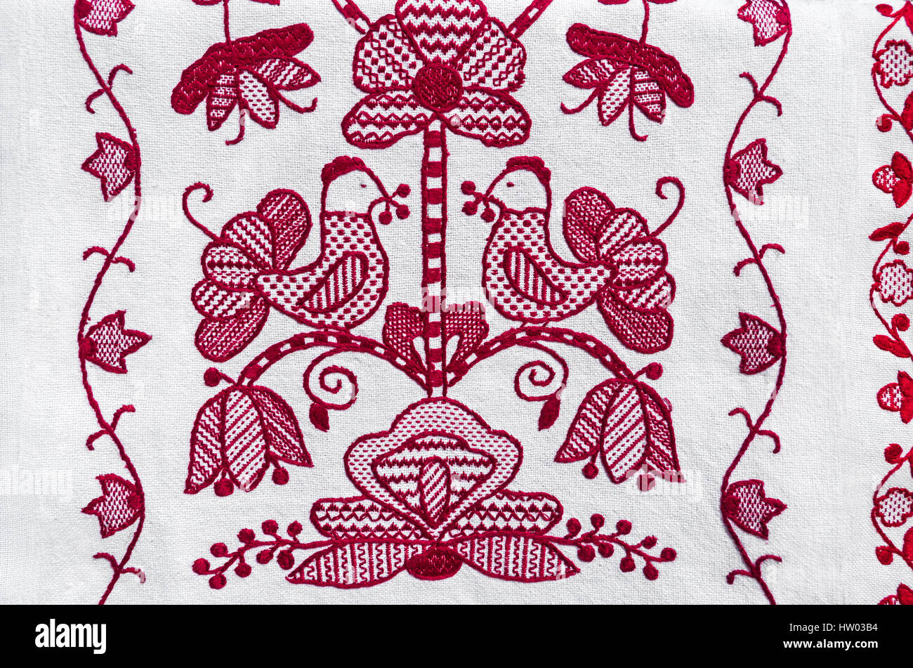 Folk embroidery red thread on white linen canvas. Traditional Ukrainian embroidery motifs Stock Photo