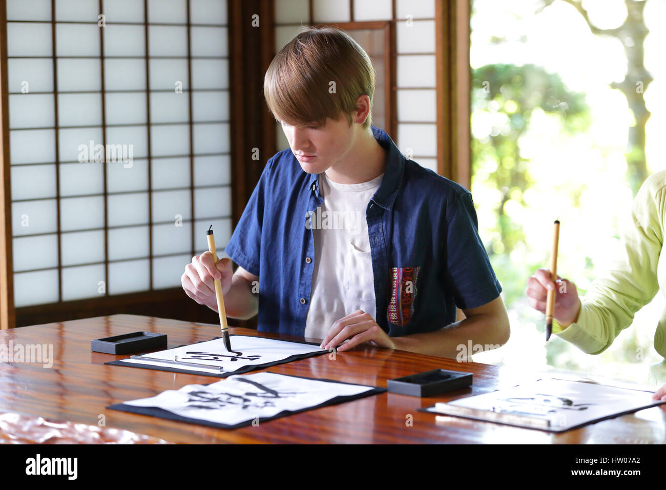 Caucasian man practicing calligraphy at traditional Japanese house Stock Photo