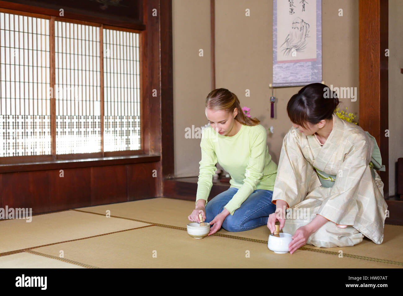 Caucasian woman enjoying tea ceremony at traditional Japanese house Stock Photo