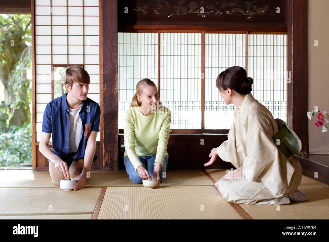 Caucasian couple enjoying tea ceremony at traditional Japanese house Stock Photo