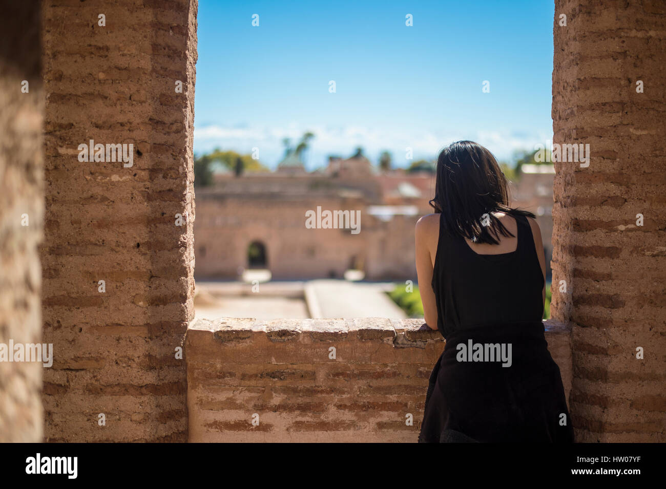 A girl enjoys the view looking out the window in Marrakesh in Morocco Stock Photo