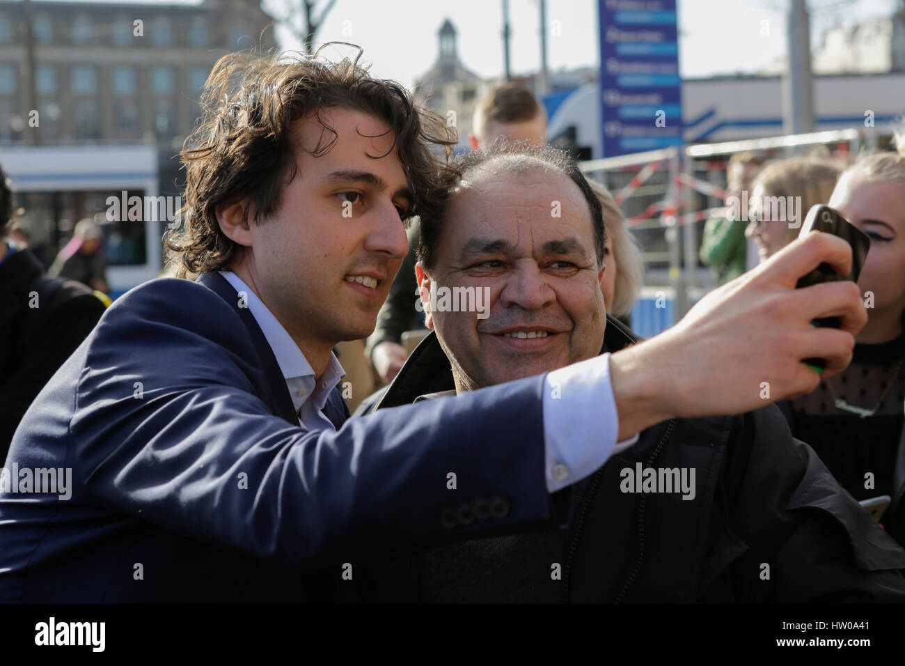 Amsterdam, Netherlands. 15th Mar, 2017. Jesse Klaver gets a selfie taken with a voter. Jesse Klaver, the party leader of the GroenLinks, canvassed together with a number of GroenLinks volunteers outside of Amsterdam Central Station, to pursue undecided voters, to vote for his party in the Dutch general election. Photo: Cronos/Michael Debets Credit: Cronos Foto/Alamy Live News Stock Photo