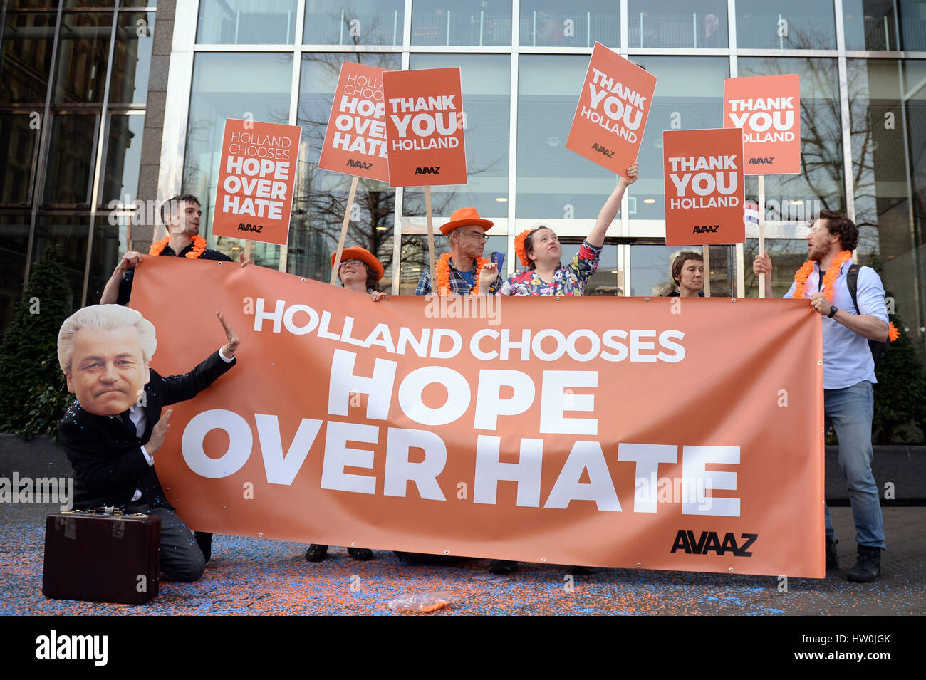 The Hague, Netherlands. 16th Mar, 2017. Demonstrators of the movement 'Avaaz' (Farzi for 'Voice') hold up posters reading 'Tahnk you Holland' and 'Holland chooses hope over hate' near the parliament in The Hague, Netherlands, 16 March 2017. The conservative-liberal party of the current Dutch Prime Minister Rutte received the most votes at the parliamentary elections on 15 March. Right-wing populist Wilders and his PVV party were less successful than expected. Photo: Daniel Reinhardt/dpa/Alamy Live News Stock Photo