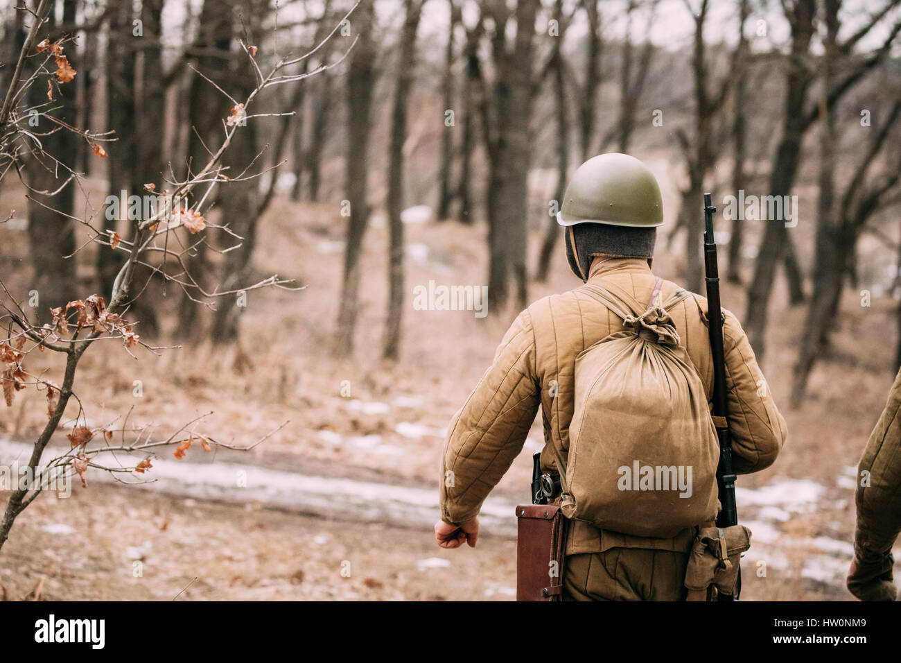Re-enactor Dressed As Soviet Russian Red Army Infantry Soldier Of World War II Marching Along Forest Road At Autumn Season Stock Photo