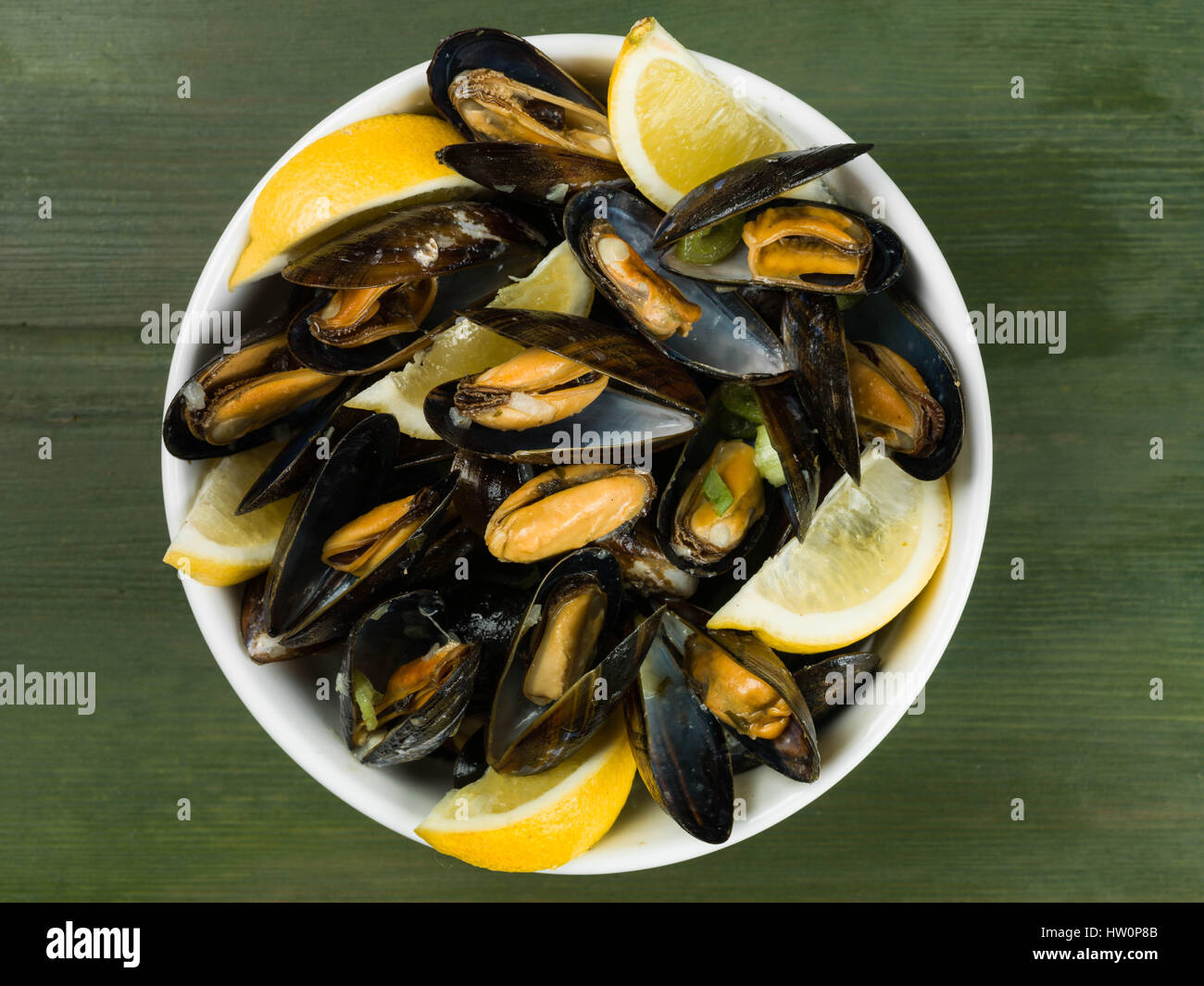 Rope Grown Mussels in a Garlic and Shallot Sauce With Slices of Lemon Stock Photo