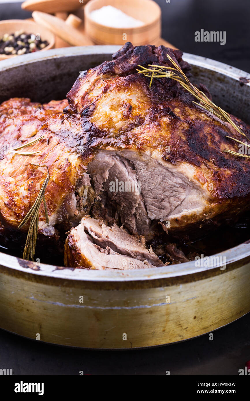 Whole oven roast pork shank with herbs and spicy marinade in roasting
