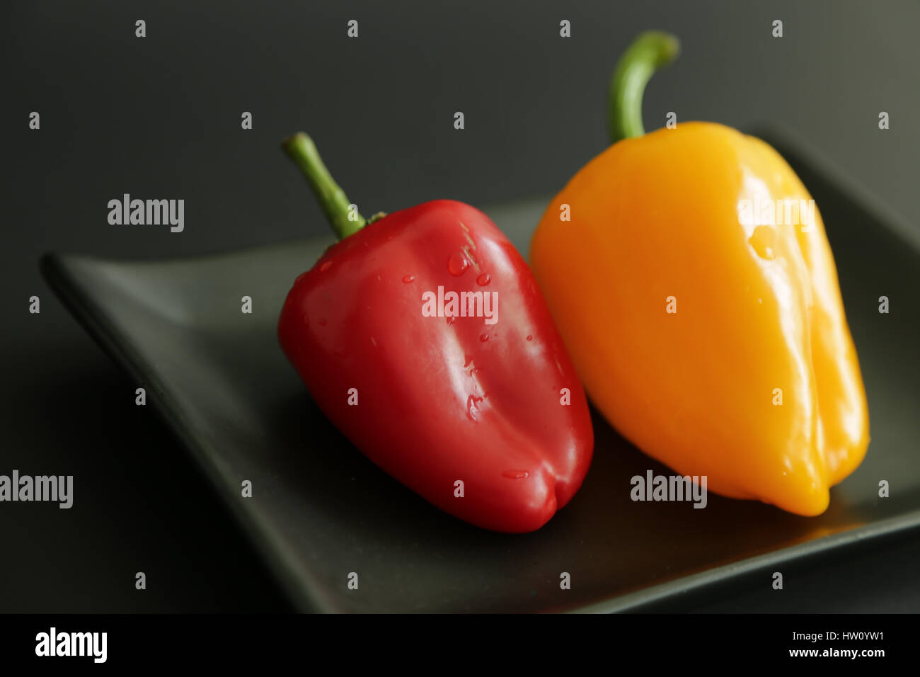 Two sweet peppers black background Stock Photo Alamy