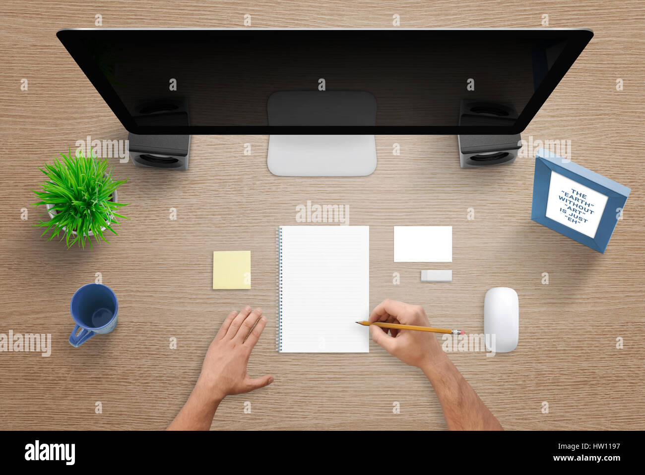 Top view of work desk with computer, pad, note, blank business card, mouse, plant, mug and desk