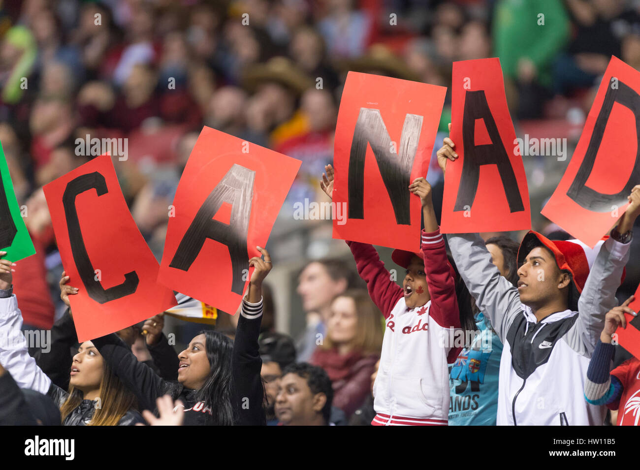 Rugby Sport Fans holding up a Canada Sign inside a indoor stadium. Stock Photo