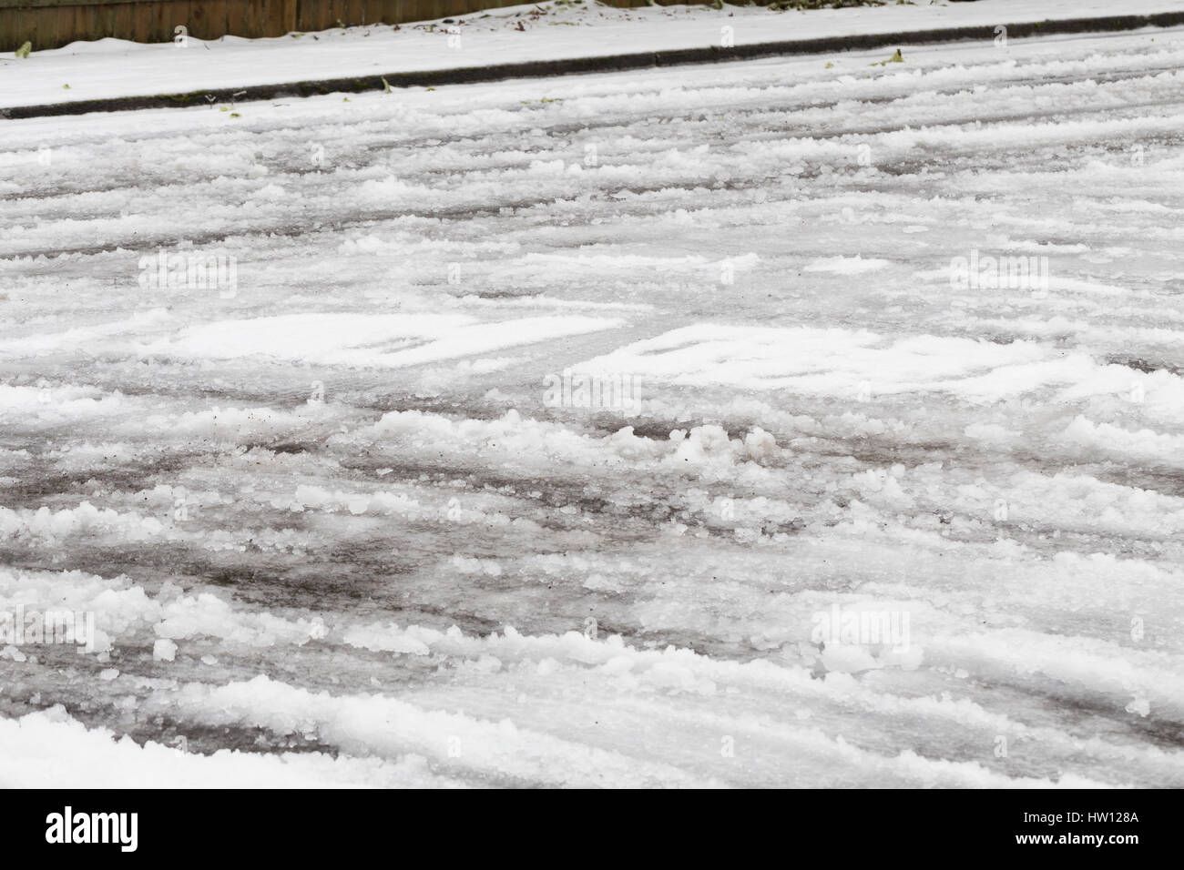Very dangerous freezing rain over snow covered roads during a winter ice storm in Eugene Oregon. Stock Photo