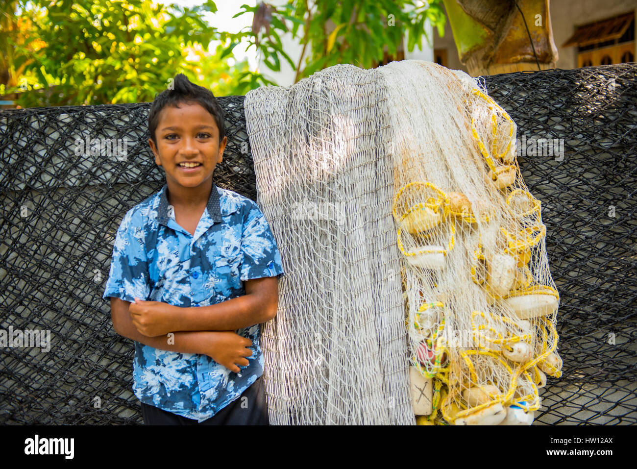 Maldives, Fenfushi Island, boy with fishing nets Stock Photo Alamy