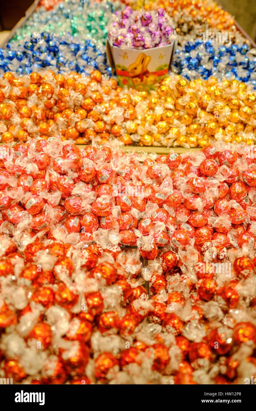 Hundreds multicoloured, assorted flavours, Lindor chocolate truffles on display at a Lindt chocolate store in London, Ontario, Canada. Stock Photo
