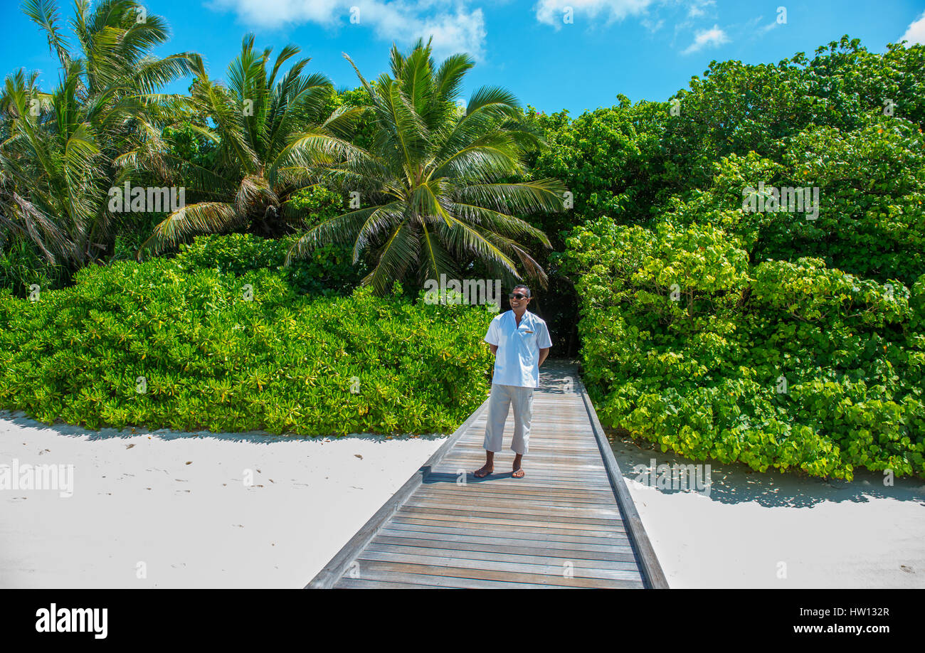 Maldives, Rangali Island. Conrad Hilton Resort. Staff memeber at Ocean villas overlooking the sea. Stock Photo
