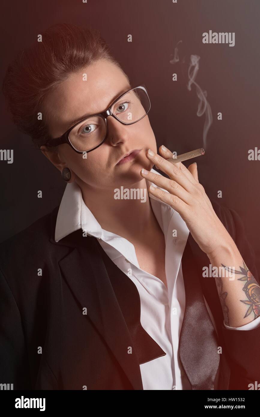 Androgynous image of person smoking a cigarette Stock Photo
