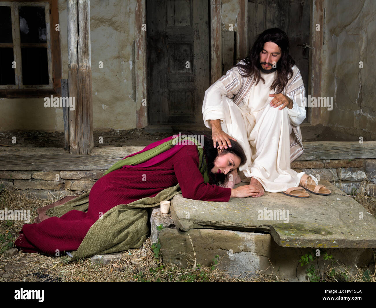 Mary Magdalene crying of shame and embalming Jesus' feet Stock Photo