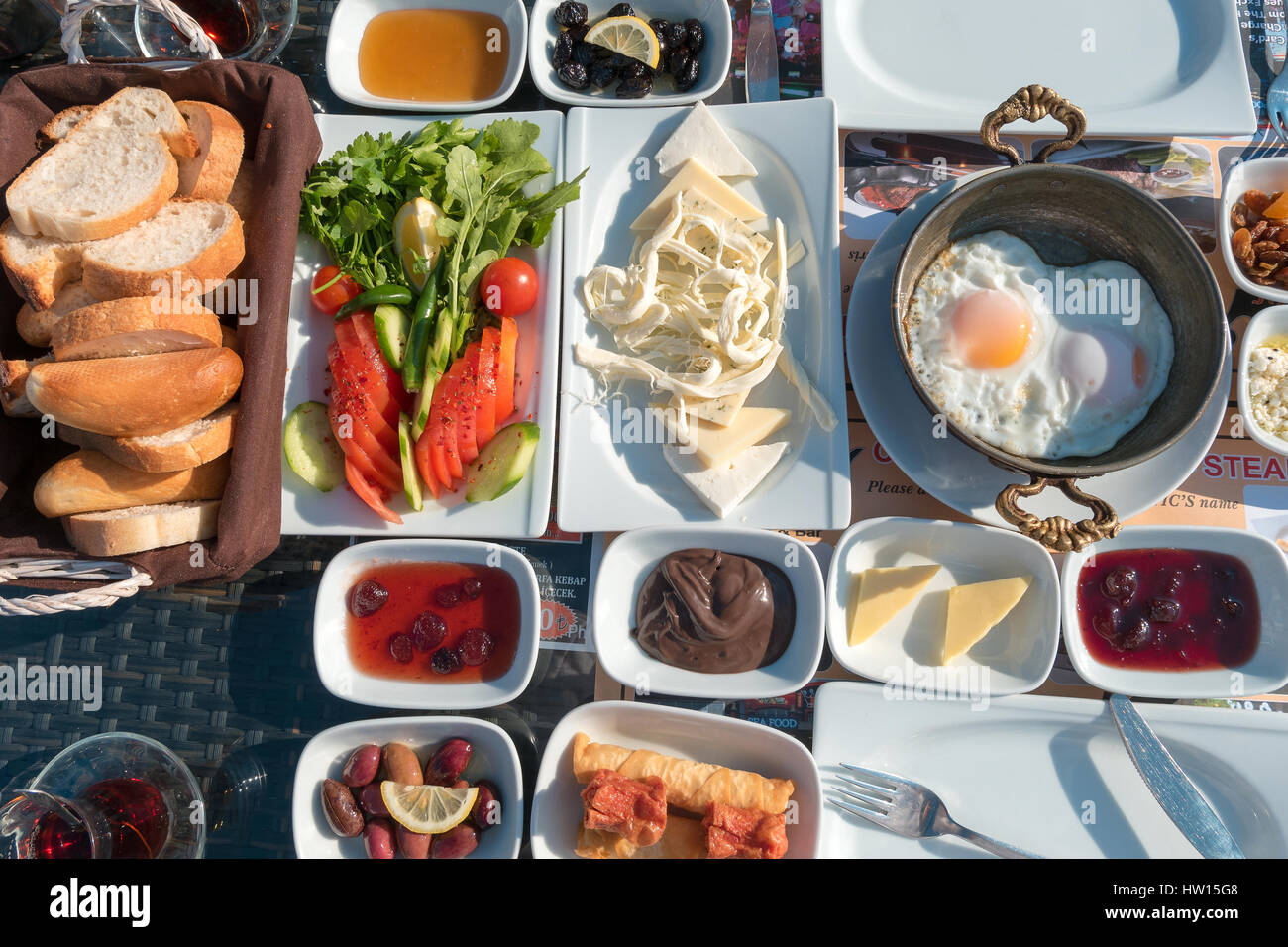 Turkish breakfast on a table with breads and eggs Stock Photo