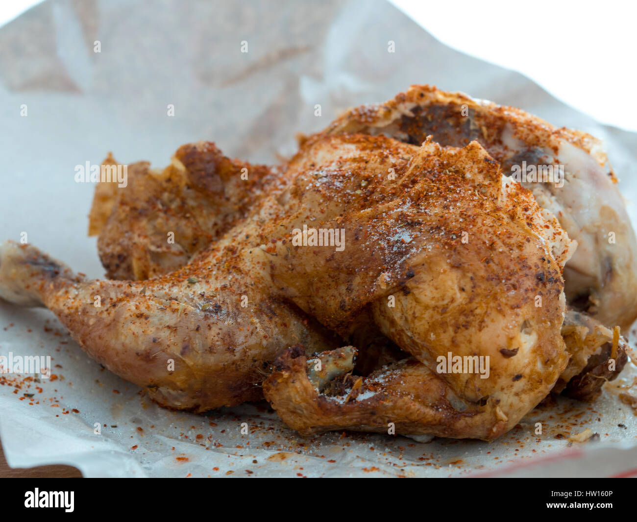 Whole roast grilled chicken on a white paper Stock Photo
